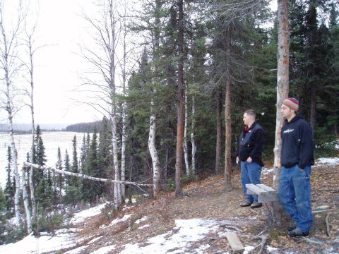 2000 Ford E350 - Two men observe a winter landscape with a lake and trees.