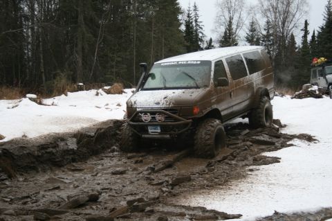 2003 Jeep TJ - Off-road van navigating difficult terrain with mud and snow.