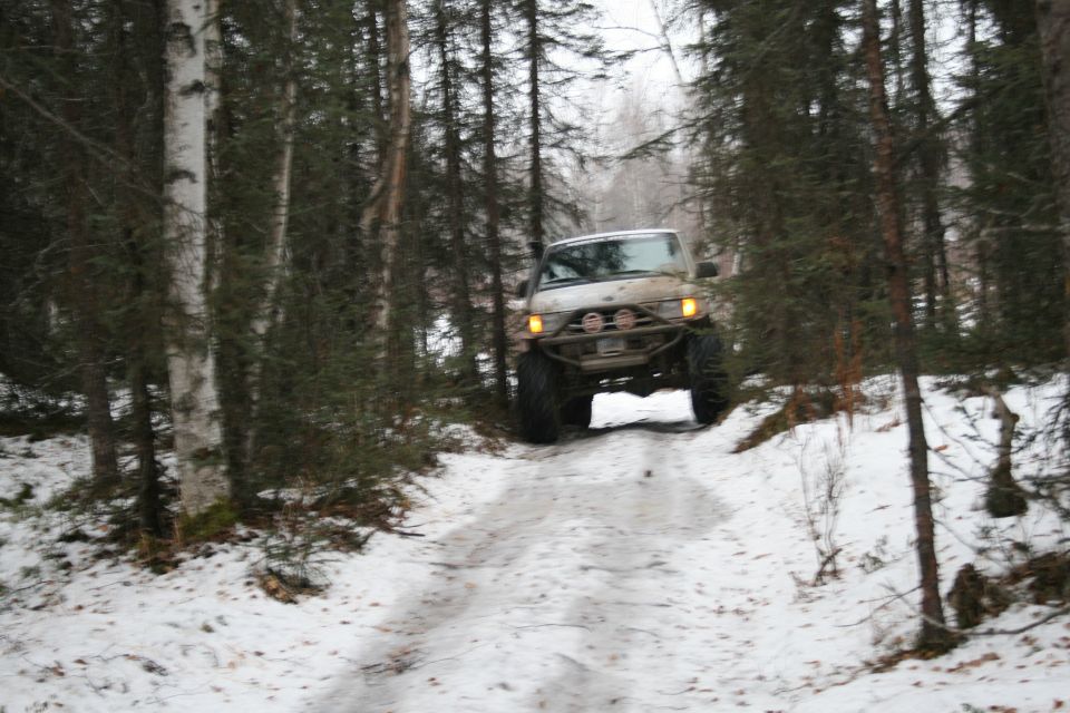 2003 Jeep TJ driving on snowy forest road