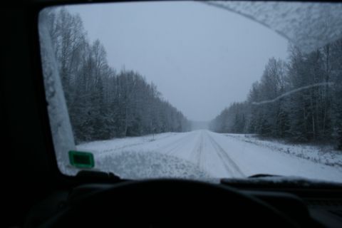 2003 Jeep TJ - Driving on a snowy road through a forest during winter.