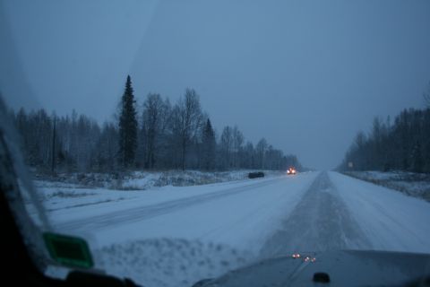 2003 Jeep TJ - Driving through a winter landscape on a snow-covered road with limited visibility.