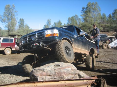 1995 Ford Bronco - This 1995 Ford Bronco is navigating a challenging off-road obstacle.