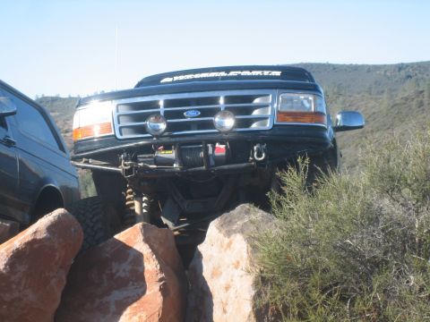 1995 Ford Bronco - This 1995 Ford Bronco navigates a rocky trail, equipped with a winch and auxiliary lights.