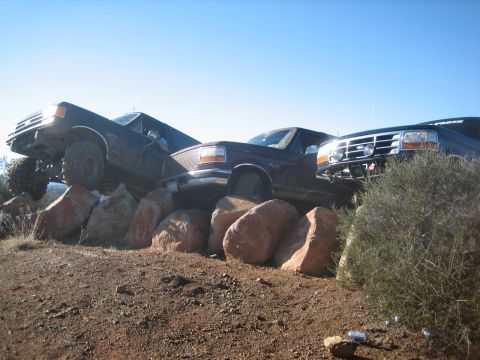 1995 Ford Bronco - Multiple trucks, one a 1995 Ford Bronco, are shown navigating a rocky terrain.