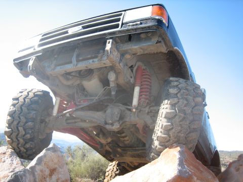 1995 Ford Bronco - This vehicle is on a rocky trail, with its front tires elevated.