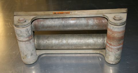 2003 Jeep TJ - A metal winch roller assembly with two horizontal rollers and a prominent orange warning label is shown.