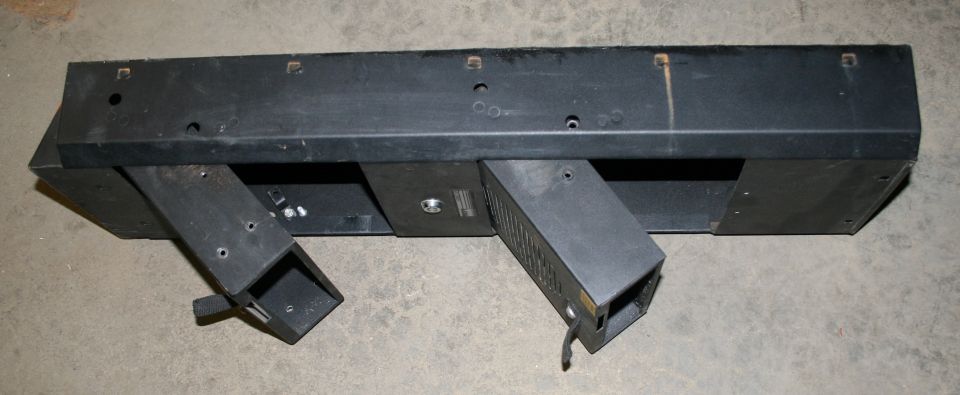 Black bumper part with two angled metal brackets attached
