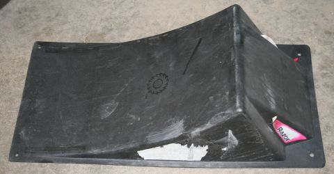 2003 Jeep TJ - A black plastic part, possibly a fender flare or bumper component, is shown from a top-down angle.