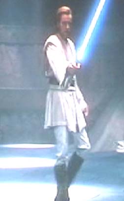 1994 Ford Crown Victoria - Man holding a blue lightsaber, with a watermark for SUPERMOTORS.NET visible.