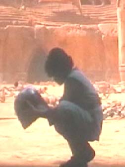 1994 Ford Crown Victoria - Person holding a helmet in a dusty outdoor setting, with a SUPERMOTORS watermark visible.