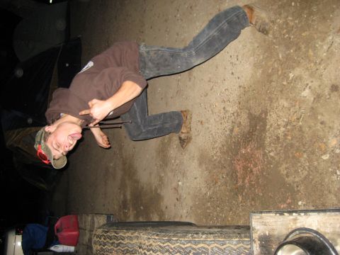 1966 Jeep CJ5 - A person is shown lying on the ground in a casual, defiant pose.