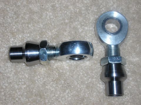 1996 Ford Bronco - Two metal rod ends are shown on a carpeted surface, with one on the left and another on the right.