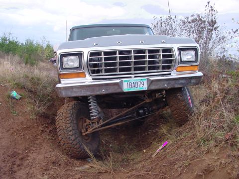 1979 Ford Bronco - This 1979 Ford Bronco is shown from the front, navigating a muddy, off-road environment.
