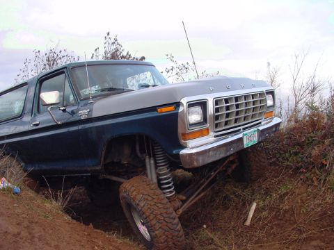 1979 Ford Bronco - This lifted Ford Bronco is shown in a 3/4 front view, navigating rough terrain.