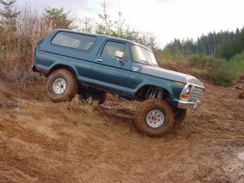 1979 Ford Bronco - This 1979 Ford Bronco navigates a challenging muddy terrain, its off-road capabilities.