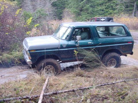 1979 Ford Bronco - This 1979 Ford Bronco navigates a muddy trail, its off-road capabilities.