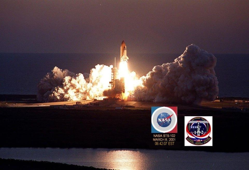 Space shuttle launch with NASA STS-102 mission details visible