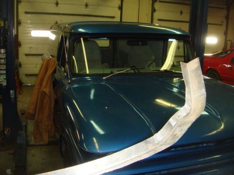 1996 Ford Bronco - A blue van is parked in a garage, with a red car visible in the background.