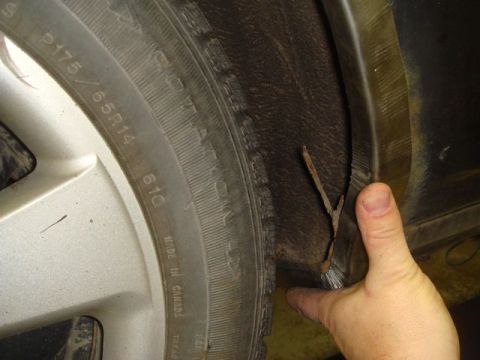 1996 Ford Bronco - Debris lodged in the wheel well liner near the tire.
