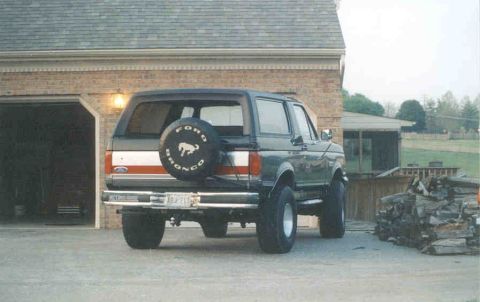 1990 Ford Bronco - Rear view of a 1990 Ford Bronco, showing the spare tire mounted on the tailgate.