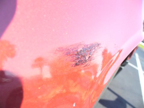1991 Ford Probe - This close-up shows significant rust and paint damage on the fender of a vehicle.