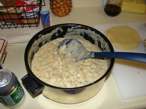 1989 Ford Bronco - A close-up view of chicken pot pie filling in a pot, accompanied by a beverage and fruit.