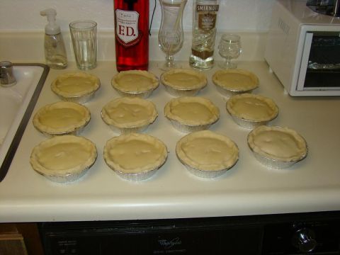 1989 Ford Bronco - A dozen unbaked pies are arranged on a kitchen counter, with bottles of E.D. and Smirnoff vodka nearby.