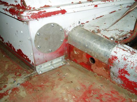 2000 Ford E350 - This photo shows a section of a vehicle's frame undergoing repairs, with visible metalwork and rivets.