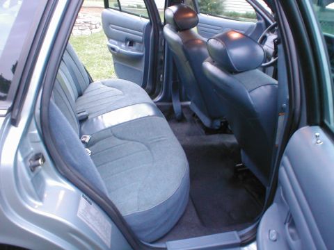 1997 Ford Crown Victoria - Interior view of a car's back and front seats, showing the upholstery and door panels.