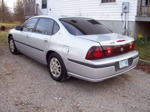 2001 Chevrolet Impala - This silver 2000 Chevrolet Impala is seen from the rear, tinted windows and a license plate.