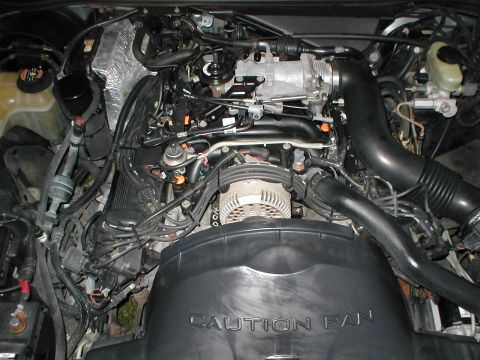 1997 Ford Crown Victoria - Engine bay detail with 'CAUTION FAN' text and Supermotors.net logo visible.