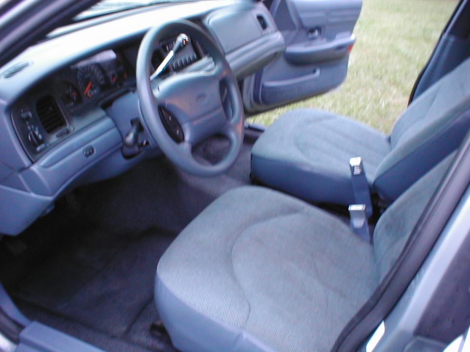 Interior shot of a 1997 Ford Crown Victoria, showing the dashboard, steering wheel, and front seats