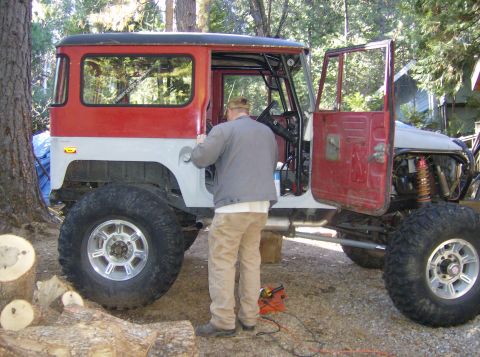 1986 Ford Bronco - This modified Toyota Land Cruiser FJ40 is undergoing work outdoors with its doors and hood removed.