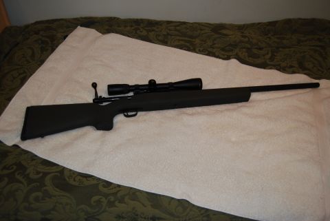 1991 Ford Bronco - A rifle with a scope is shown from the side, resting on a white cloth.