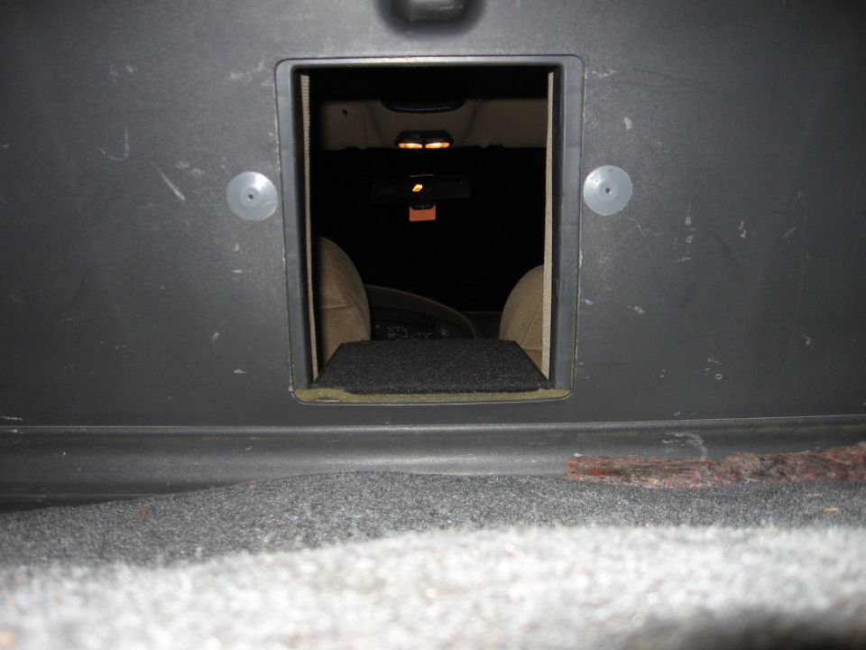 1992 Ford Crown Victoria interior seen through trunk opening, showing beige seats and dashboard
