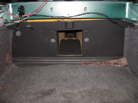1992 Ford Crown Victoria - The trunk interior shows a speaker enclosure and exposed wiring, with carpeting and a green painted panel visible.
