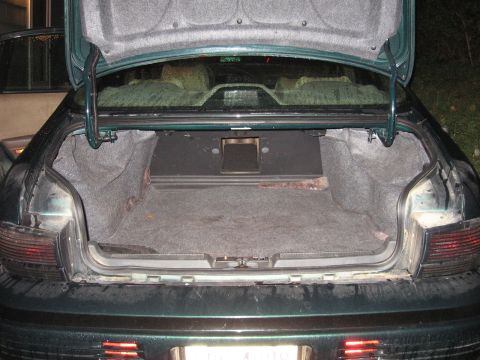 1992 Ford Crown Victoria - The interior of a car's trunk is visible with the lid open, revealing a speaker box.