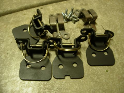 1985 Toyota Hilux - A collection of door hinges and associated hardware, including screws, are displayed on a textured surface.