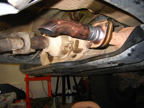 2001 Jeep Wrangler - Underbody shot taken from beneath a vehicle on jack stands, showing the transfer case output with a heat-discolored slip yoke eliminator st…