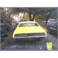 1971 Mercury Cyclone - This yellow car is seen from the rear, with its horizontal taillights visible.