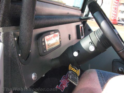 1990 Ford Bronco - close-up of a 4x4 interior showing a small color display screen, toggle switches and the black steering column.