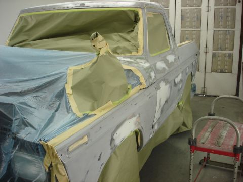 1979 Ford Bronco - Bodywork on a 1979 Ford Bronco, masked and prepped for painting in a workshop.