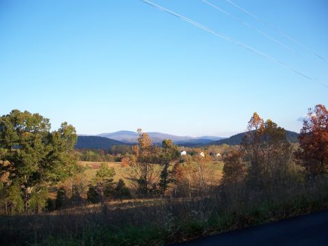 1971 Ford Ranchero - A scenic view of the countryside during the fall, with mountains in the distance under a bright blue sky.