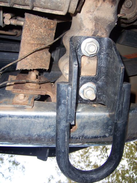 1996 Ford Bronco - Undercarriage view of a vehicle's frame and a mounted tow hitch, with visible signs of wear and rust.