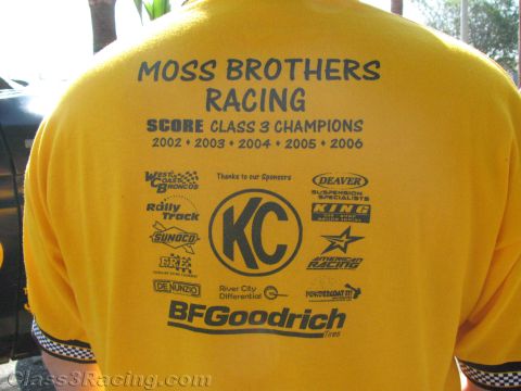 1990 Ford Bronco - Back of a yellow Moss Brothers Racing T-shirt printed with SCORE Class 3 champion years and a grid of sponsor logos.