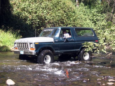 1979 Ford Bronco - This 1979 Ford Bronco navigates a rocky stream, its "CREE OFFROAD" sticker visible on the windshield.