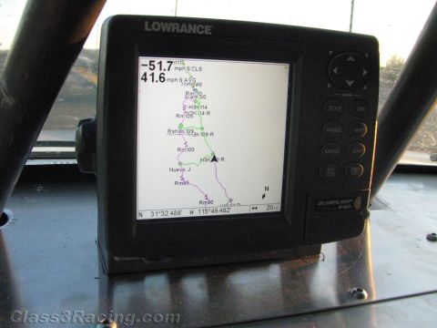 1990 Ford Bronco - Lowrance GPS chartplotter mounted in a vehicle displays a colored route map with speed readouts and coordinates on its screen.