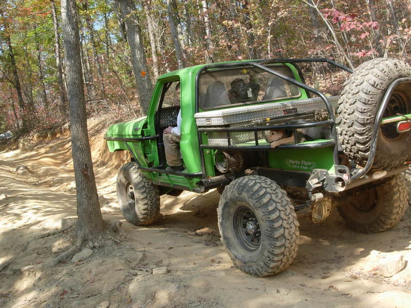 Green 1978 Ford Bronco modified for off-roading, seen from the front-three-quarter view