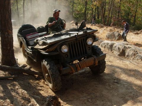1978 Ford Bronco - A man navigates a off-road course in a vintage Jeep.