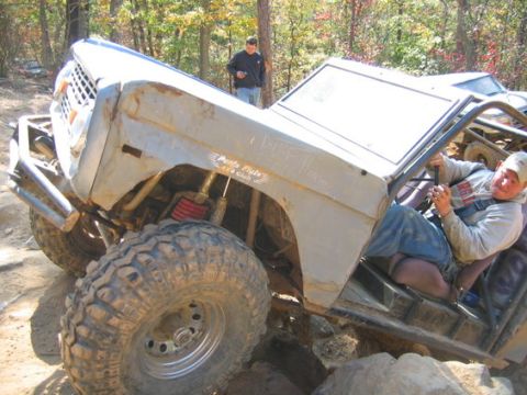 1978 Ford Bronco - This heavily modified off-road vehicle navigates a challenging rocky trail with a driver at the wheel.